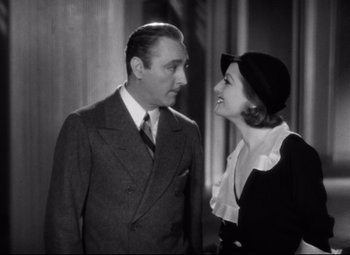 Movie still from “Grand Hotel” (1932), directed by Edmund Goulding – An older man and woman standing next to each other; Medium shot, Low angle