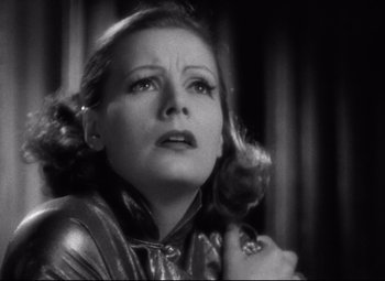 Movie still from “Grand Hotel” (1932), directed by Edmund Goulding – An old black and white photo of a woman looking up; Close Up shot, Low angle