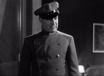 Movie still from “Grand Hotel” (1932), directed by Edmund Goulding – A man in a military uniform wearing a hat; Medium shot, Low angle