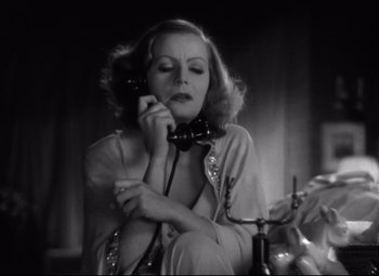 Movie still from “Grand Hotel” (1932), directed by Edmund Goulding – An old photo of a woman talking on a phone; Close Up shot, Low angle