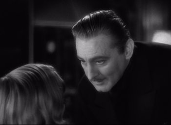 Movie still from “Grand Hotel” (1932), directed by Edmund Goulding – A black and white photo of a man and a girl; Close Up shot, Over the shoulder angle