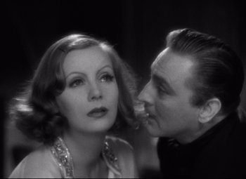 Movie still from “Grand Hotel” (1932), directed by Edmund Goulding – An old photo of a man and a woman looking at each other; Close Up shot, Low angle