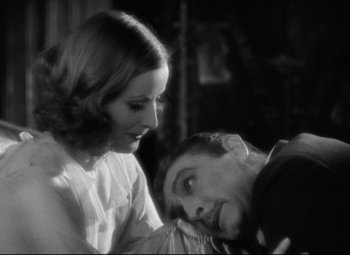 Movie still from “Grand Hotel” (1932), directed by Edmund Goulding – A man and a woman looking at one another; Close Up shot, Over the shoulder angle