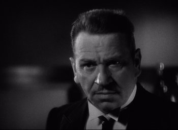 Movie still from “Grand Hotel” (1932), directed by Edmund Goulding – An older man wearing a suit and tie; Close Up shot, Low angle