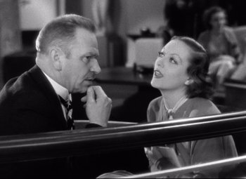 Movie still from “Grand Hotel” (1932), directed by Edmund Goulding – An older man and a younger woman are talking together; Close Up shot, Low angle