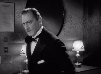Movie still from “Grand Hotel” (1932), directed by Edmund Goulding – A black and white photo of a man in a tuxedo; Close Up shot, Low angle