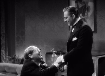Movie still from “Grand Hotel” (1932), directed by Edmund Goulding – A man in a suit shaking hands with another man in a suit; Medium shot, Over the shoulder angle