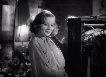 Movie still from “Grand Hotel” (1932), directed by Edmund Goulding – An old black and white photo of a young woman; Medium shot, Low angle