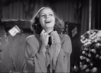 Movie still from “Grand Hotel” (1932), directed by Edmund Goulding – An old photo of a woman holding a phone up to her ear; Close Up shot, Low angle