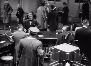 Movie still from “Grand Hotel” (1932), directed by Edmund Goulding – A black and white photo of a group of men in suits; Wide shot, High angle