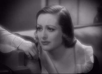 Movie still from “Grand Hotel” (1932), directed by Edmund Goulding – An old black and white photo of a woman looking at the camera; Close Up shot, High angle