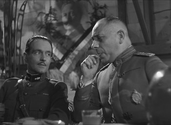Movie still from “The Grand Illusion” (1937), directed by Jean Renoir – A black and white photo of two men in military uniforms; Medium shot, Over the shoulder angle