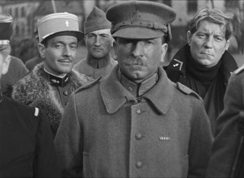 Movie still from “The Grand Illusion” (1937), directed by Jean Renoir – Black and white photograph of a group of men in military uniforms; Medium shot, Low angle