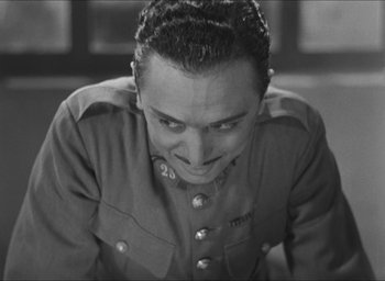 Movie still from “The Grand Illusion” (1937), directed by Jean Renoir – A man in a military uniform is looking at the camera; Close Up shot, High angle