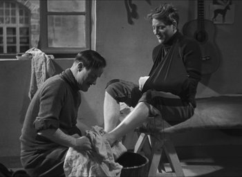 Movie still from “The Grand Illusion” (1937), directed by Jean Renoir – A man and a woman sitting on a chair; Medium shot, Low angle