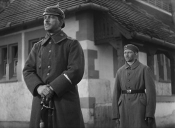 Movie still from “The Grand Illusion” (1937), directed by Jean Renoir – A black and white photo of two men in military uniforms; Medium shot, Low angle