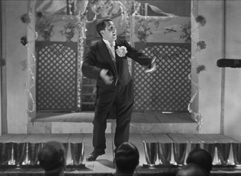 Movie still from “The Grand Illusion” (1937), directed by Jean Renoir – A black and white photo of a man on a stage; Medium shot, Low angle