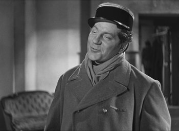 Movie still from “The Grand Illusion” (1937), directed by Jean Renoir – A man wearing a hat and a coat; Medium shot, Over the shoulder angle