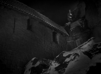 Movie still from “The Grand Illusion” (1937), directed by Jean Renoir – A man is jumping off of a building in the dark; Extreme Wide shot, High angle