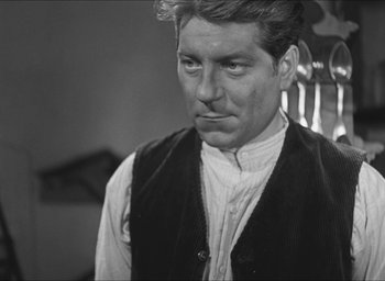 Movie still from “The Grand Illusion” (1937), directed by Jean Renoir – A man in a black and white photo looking to his left; Close Up shot, Low angle