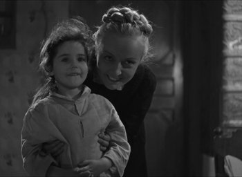 Movie still from “The Grand Illusion” (1937), directed by Jean Renoir – A woman and a child are posing for a picture; Close Up shot, Over the shoulder angle