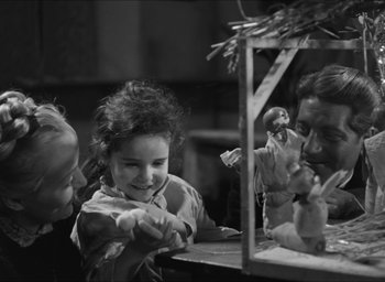 Movie still from “The Grand Illusion” (1937), directed by Jean Renoir – Two children and an adult looking in a mirror; Medium shot, Over the shoulder angle
