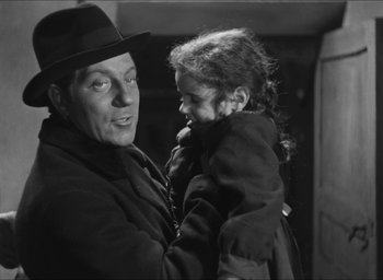Movie still from “The Grand Illusion” (1937), directed by Jean Renoir – An older man holding a little girl in his arms; Close Up shot, Over the shoulder angle