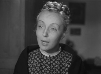 Movie still from “The Grand Illusion” (1937), directed by Jean Renoir – An old photo of a woman with a braid in her hair; Close Up shot, High angle