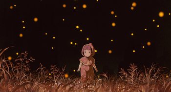 Movie still from “Grave of the Fireflies” (1988), directed by Isao Takahata – A girl standing in a field with fireflies in the background; Wide shot, Low angle