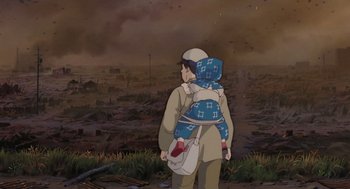 Movie still from “Grave of the Fireflies” (1988), directed by Isao Takahata – A person with a baby in a sling walking through a field; Medium shot, Low angle
