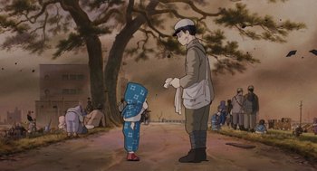 Movie still from “Grave of the Fireflies” (1988), directed by Isao Takahata – An animated scene of a man and a child; Wide shot, Low angle