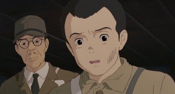 Movie still from “Grave of the Fireflies” (1988), directed by Isao Takahata – An animated picture of a man with a surprised look on his face; Close Up shot, Over the shoulder angle