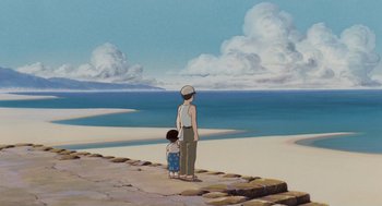 Movie still from “Grave of the Fireflies” (1988), directed by Isao Takahata – A man and a small child standing on the beach; Extreme Wide shot, High angle