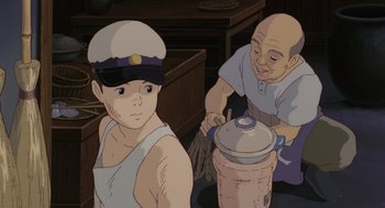 Movie still from “Grave of the Fireflies” (1988), directed by Isao Takahata – A man and a boy are cooking something in a pot; Medium shot, Low angle