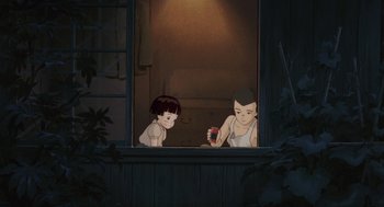 Movie still from “Grave of the Fireflies” (1988), directed by Isao Takahata – Two children looking out of a window at night; Wide shot, High angle