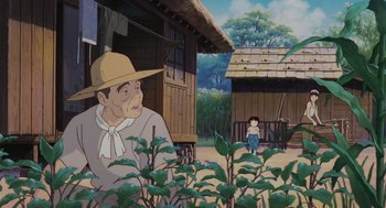 Movie still from “Grave of the Fireflies” (1988), directed by Isao Takahata – An animated scene of a man and a child in a yard; Wide shot, Over the shoulder angle