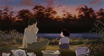 Movie still from “Grave of the Fireflies” (1988), directed by Isao Takahata – A couple of people sitting on the ground near a body of water; Wide shot, Low angle
