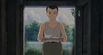 Movie still from “Grave of the Fireflies” (1988), directed by Isao Takahata – A man holding a tray of food in front of a painting; Medium shot, Low angle