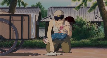 Movie still from “Grave of the Fireflies” (1988), directed by Isao Takahata – An animated scene of a man holding a child; Medium shot, Low angle