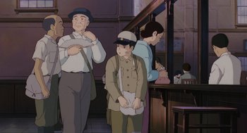 Movie still from “Grave of the Fireflies” (1988), directed by Isao Takahata – A group of men and women standing next to each other; Medium shot, Low angle