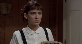 Movie still from “Great Balls of Fire!” (1989), directed by Jim McBride – A woman in a white shirt and black suspenders; Close Up shot, Over the shoulder angle