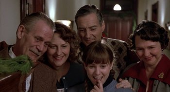 Movie still from “Great Balls of Fire!” (1989), directed by Jim McBride – A group of people standing next to each other in a room; Close Up shot, Low angle