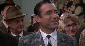 Movie still from “Great Balls of Fire!” (1989), directed by Jim McBride – A man in a suit and a tie; Close Up shot, Over the shoulder angle