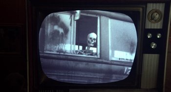 Movie still from “Great Balls of Fire!” (1989), directed by Jim McBride – A picture of a skull sitting in a window of a train car; Extreme Close Up shot, Low angle