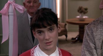 Movie still from “Great Balls of Fire!” (1989), directed by Jim McBride – A young girl in a red and white sweater and a man in a black suit; Close Up shot, Over the shoulder angle