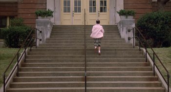 Movie still from “Great Balls of Fire!” (1989), directed by Jim McBride – A woman walking down a set of stairs; Extreme Wide shot, High angle