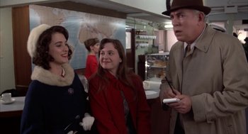 Movie still from “Great Balls of Fire!” (1989), directed by Jim McBride – A group of people standing next to each other in a room; Medium shot, Over the shoulder angle