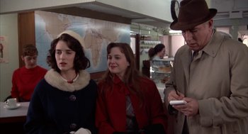 Movie still from “Great Balls of Fire!” (1989), directed by Jim McBride – A group of people standing next to each other in a room; Medium shot, Over the shoulder angle