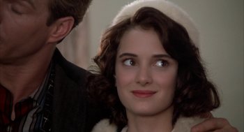 Movie still from “Great Balls of Fire!” (1989), directed by Jim McBride – A woman in a white hat looking at the camera; Close Up shot, Over the shoulder angle