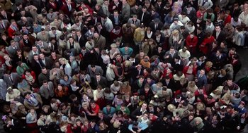 Movie still from “Great Balls of Fire!” (1989), directed by Jim McBride – An overhead view of a crowd of people in suits; Extreme Wide shot, Overhead angle